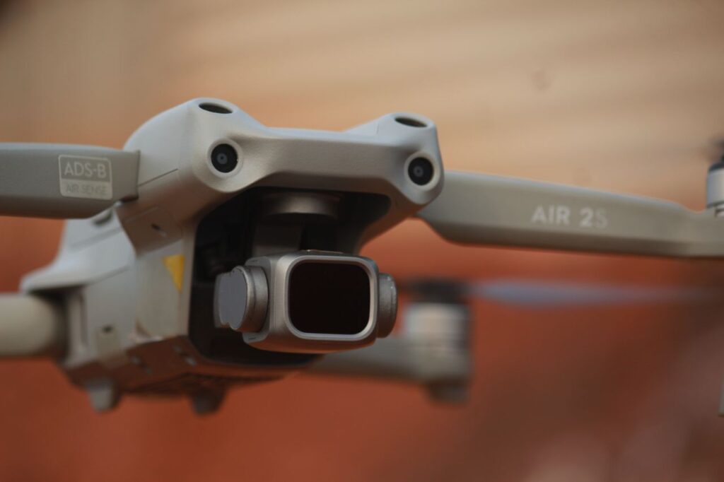 Close-up of a drone camera and sensor module, illustrating IMU sensors used for stabilization