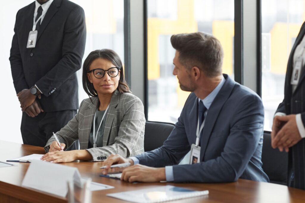 Business team in a meeting reviewing AI tools on laptops